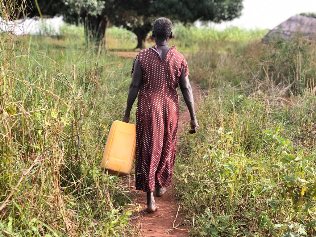 neverthirst - Cecelia walking with jerry can