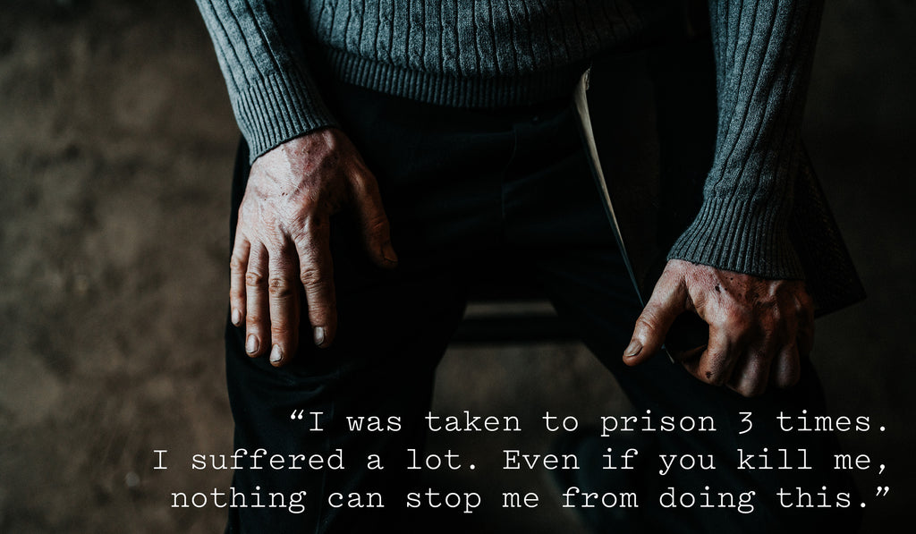 Quote from 'E' over a photo of his hands: "I was taken to prison 3 times. I suffered a lot. Even if you kill me, nothing can stop me from doing this."